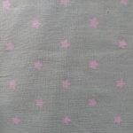 Tela de estrellas rosa bebé sobre fondo beig